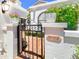 Charming wrought iron gate with lush landscaping and decorative planters and house number at 10120 E Topaz Dr, Scottsdale, AZ 85258