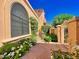 Landscaped front yard with a stone walkway and gated entry at 10120 E Topaz Dr, Scottsdale, AZ 85258