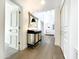 Elegant hallway with wood floors, a decorative mirror and cabinet, and access to various rooms, offering a seamless flow at 10120 E Topaz Dr, Scottsdale, AZ 85258