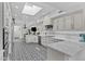 Bright, modern kitchen with white cabinets, stainless appliances, and a patterned black and white tile floor at 10120 E Topaz Dr, Scottsdale, AZ 85258