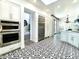 Bright kitchen showcasing patterned tile floors, stainless steel appliances, and white cabinetry at 10120 E Topaz Dr, Scottsdale, AZ 85258