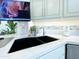 The kitchen sink with modern fixtures, white countertops and cabinetry, and under-cabinet lighting at 10120 E Topaz Dr, Scottsdale, AZ 85258