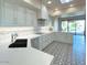 Modern kitchen with white cabinets, quartz countertops and a breakfast bar at 10120 E Topaz Dr, Scottsdale, AZ 85258