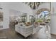 Spacious living room features modern furniture, a view of the yard, and beautiful wood flooring at 10120 E Topaz Dr, Scottsdale, AZ 85258