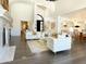Spacious living room with high ceilings, white sofas, and hardwood floors at 10120 E Topaz Dr, Scottsdale, AZ 85258