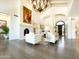 Bright living room with hardwood floors, white sofas, fireplace, and open floor plan at 10120 E Topaz Dr, Scottsdale, AZ 85258
