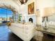Bright living room with comfortable white couches and elegant gold accents at 10120 E Topaz Dr, Scottsdale, AZ 85258