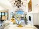 Grand living room with high ceilings, a decorative chandelier, a fireplace, and views of the outdoor area at 10120 E Topaz Dr, Scottsdale, AZ 85258
