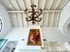 Living room with beautiful chandelier and high vaulted ceiling, art over fireplace at 10120 E Topaz Dr, Scottsdale, AZ 85258