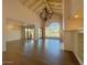 Open living area with vaulted ceilings, chandelier, and access to patio at 10120 E Topaz Dr, Scottsdale, AZ 85258