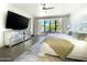 A bright and airy main bedroom showcases a bay window, dark floors and mirrored cabinets at 10120 E Topaz Dr, Scottsdale, AZ 85258
