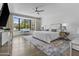 Spacious main bedroom with ceiling fan, desk area, and natural light at 10120 E Topaz Dr, Scottsdale, AZ 85258