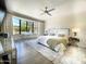 The main bedroom is bright and airy with a ceiling fan, bay window, and hard wood floors at 10120 E Topaz Dr, Scottsdale, AZ 85258