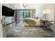 Bright bedroom featuring large window, TV, mirrored dresser, ceiling fan, and a cozy bed with a green throw at 10120 E Topaz Dr, Scottsdale, AZ 85258