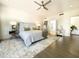 This well-lit main bedroom has a spacious feel, hardwood floors and a large decorative rug at 10120 E Topaz Dr, Scottsdale, AZ 85258