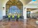 Outdoor living space features comfortable seating and a large arched window framing the outdoor scenery at 10120 E Topaz Dr, Scottsdale, AZ 85258