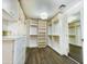 Spacious walk-in closet featuring custom shelving, drawers, and ample storage space for clothing and accessories at 10120 E Topaz Dr, Scottsdale, AZ 85258