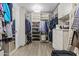Spacious walk-in closet featuring custom shelving, ample storage, and organized hanging spaces at 10120 E Topaz Dr, Scottsdale, AZ 85258