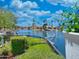Scenic waterfront view featuring lush landscaping, upscale homes, and a serene lake on a sunny day at 10120 E Topaz Dr, Scottsdale, AZ 85258
