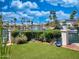 Picturesque waterfront view showcases lush landscaping, calm water, and neighborhood of beautiful homes at 10120 E Topaz Dr, Scottsdale, AZ 85258