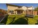 Expansive backyard featuring a trampoline, outdoor seating, lush lawn, and a covered patio for relaxation at 10129 E Ampere Ave, Mesa, AZ 85212