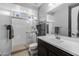 Clean bathroom with a shower featuring glass doors and a dark vanity with ample counter space at 10129 E Ampere Ave, Mesa, AZ 85212