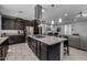 Gourmet kitchen island with granite counters, stainless appliances, and dark wood cabinetry at 10129 E Ampere Ave, Mesa, AZ 85212