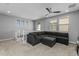 Comfortable living room with a large sectional couch and natural light from multiple windows at 10129 E Ampere Ave, Mesa, AZ 85212