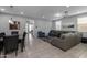 Open-concept living and dining area featuring tile floors and neutral gray color palette at 10129 E Ampere Ave, Mesa, AZ 85212