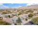 Breathtaking aerial view of a desert community showcasing well-maintained homes with mountain views and beautiful desert landscaping at 10564 E Tierra Buena Ln, Scottsdale, AZ 85255