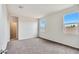 Well-lit bedroom featuring carpet and views from two windows at 1144 Se Mullberry St, Florence, AZ 85132