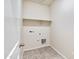 Laundry room with tile flooring and shelving at 1144 Se Mullberry St, Florence, AZ 85132