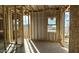 A framed room with window showing the stud and sheeting in an unfinished home under construction at 11441 E Utopia Ave, Mesa, AZ 85212