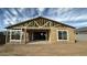 Exterior view of framed home with sheeting in a new build showing windows and roof structure at 11441 E Utopia Ave, Mesa, AZ 85212