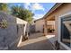 Small gravel backyard with block wall, firepit, and grill at 11849 N 51St Dr, Glendale, AZ 85304