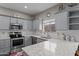 Modern kitchen with gray cabinets, granite countertops, and stainless steel appliances at 11849 N 51St Dr, Glendale, AZ 85304