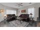 Living room with brown leather couches and a large TV at 11849 N 51St Dr, Glendale, AZ 85304