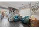 Living room with teal armchairs and dark hardwood floors at 11849 N 51St Dr, Glendale, AZ 85304