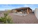 Landscaped backyard with a covered patio and gravel at 11995 E Pivot Peak --, Gold Canyon, AZ 85118