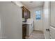 Bright laundry room with washer, dryer, and cabinets at 11995 E Pivot Peak --, Gold Canyon, AZ 85118