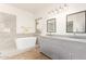 Elegant bathroom with double vanity and soaking tub at 13756 W Watson Ln, Surprise, AZ 85379