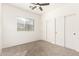 Bright bedroom with window, ceiling fan, and carpet at 13756 W Watson Ln, Surprise, AZ 85379