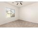 Bright bedroom with window, ceiling fan, and carpet at 13756 W Watson Ln, Surprise, AZ 85379