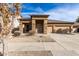 Tan one-story house with a two-car garage and desert landscaping at 13756 W Watson Ln, Surprise, AZ 85379