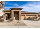 Single-story home with stone accents and a two-car garage at 13756 W Watson Ln, Surprise, AZ 85379