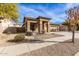 Tan one-story house with a two-car garage and desert landscaping at 13756 W Watson Ln, Surprise, AZ 85379