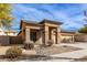 Tan two-story house with a three-car garage and rock accents at 13756 W Watson Ln, Surprise, AZ 85379