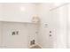 Bright laundry room with built-in shelving and space for a water softener at 13756 W Watson Ln, Surprise, AZ 85379