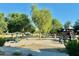 Community playground with play equipment and shaded seating at 13756 W Watson Ln, Surprise, AZ 85379