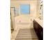 Bathroom featuring a soaking tub, shower, and dark wood vanity at 15704 W Taylor St, Goodyear, AZ 85338